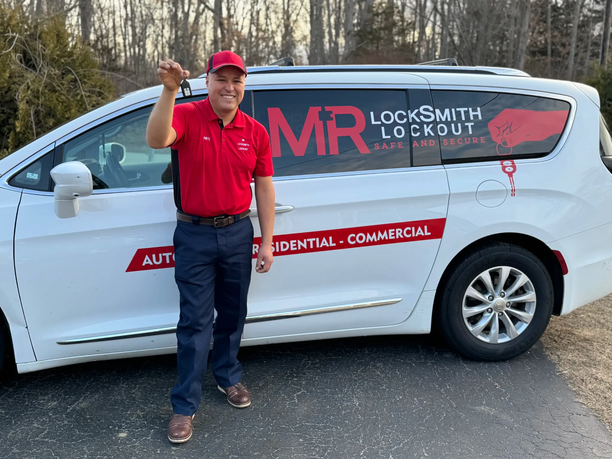 Dante Salcedo holding a car key beside a Dante Mobile Locksmith service van