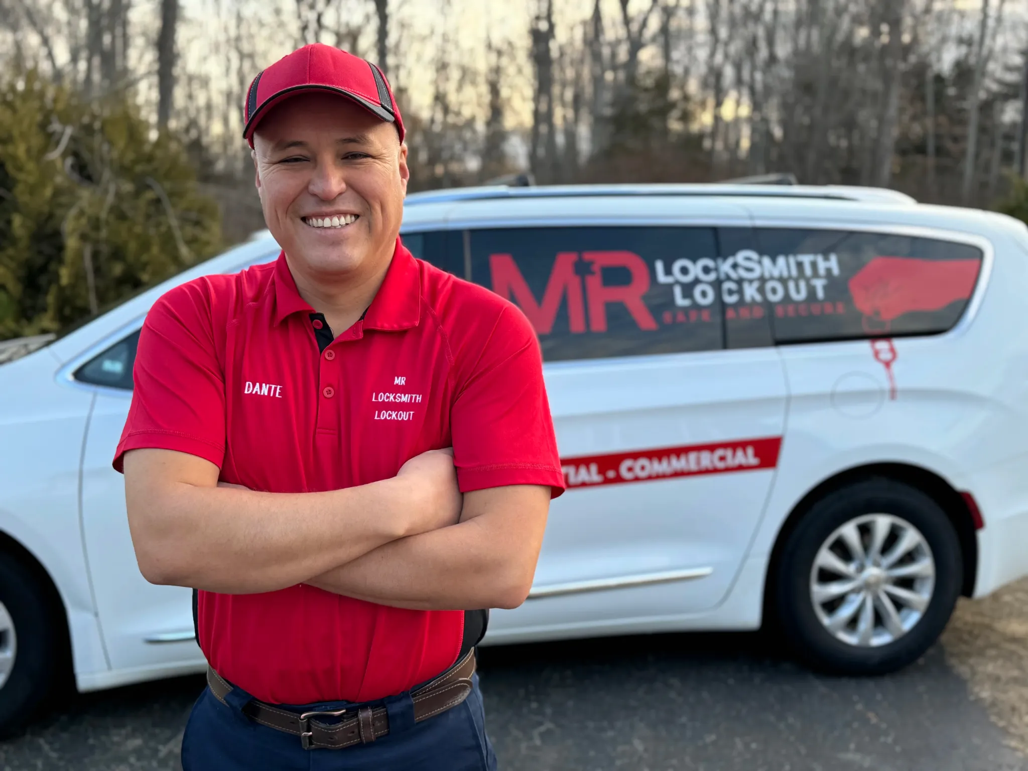 Dante Salcedo, founder of Dante Mobile Locksmith, standing in front of his service van